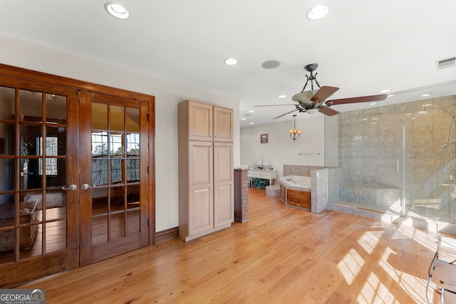 interior space with recessed lighting, visible vents, a shower stall, wood finished floors, and a bath