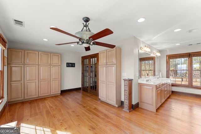 interior space with light wood-type flooring, visible vents, light brown cabinetry, and recessed lighting