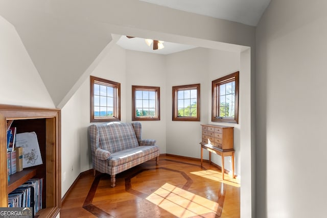 sitting room featuring baseboards, light wood-style flooring, and a healthy amount of sunlight