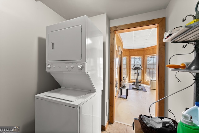 clothes washing area with laundry area and stacked washer and clothes dryer