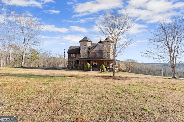 back of property featuring a yard