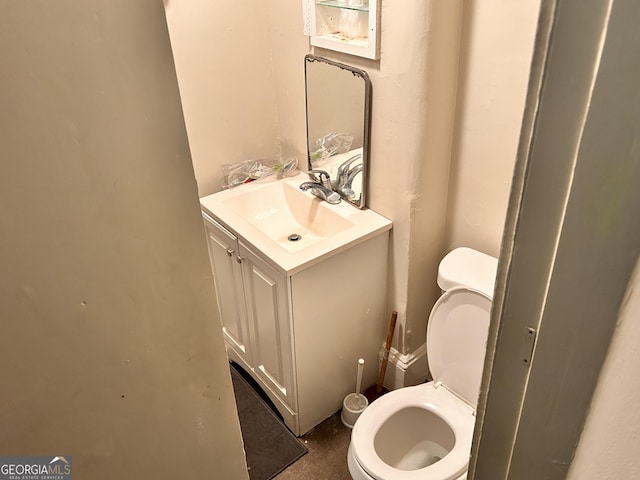 half bathroom with toilet and vanity