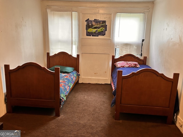 bedroom with dark colored carpet