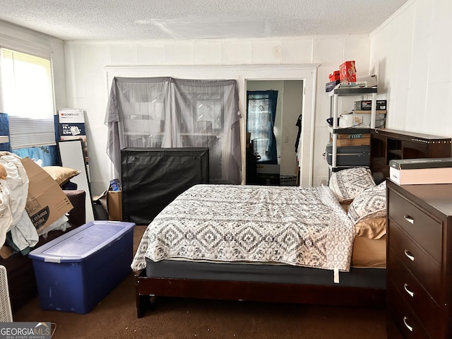 bedroom featuring carpet and a textured ceiling