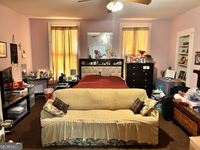 carpeted bedroom featuring ceiling fan and multiple windows