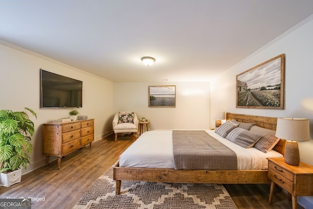 bedroom with wood finished floors and baseboards