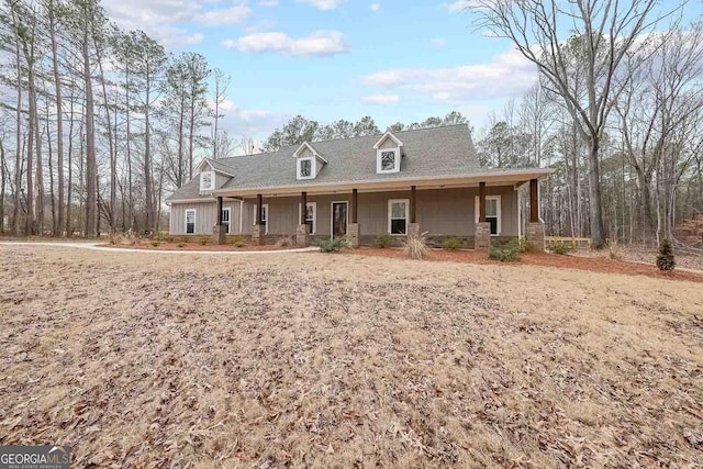 view of front of property with a shingled roof and covered porch