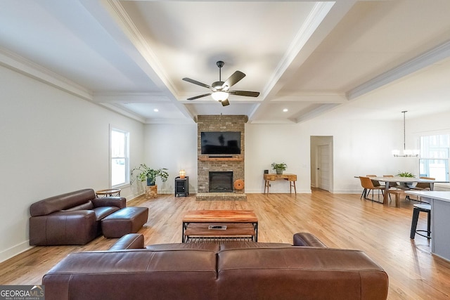 living room featuring plenty of natural light, light wood-style flooring, and beamed ceiling