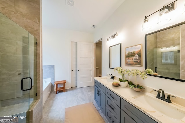 full bath with double vanity, a sink, visible vents, and a shower stall