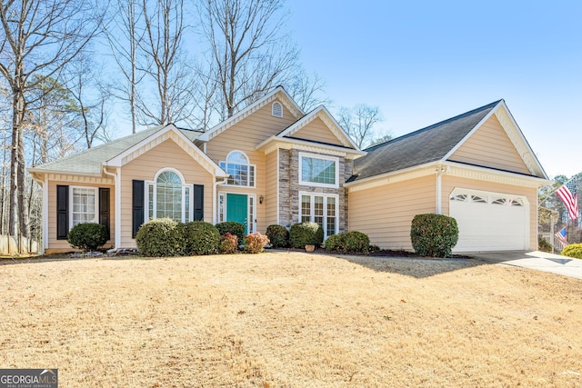 traditional-style home with a garage, stone siding, and driveway