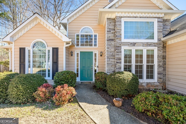 doorway to property featuring stone siding