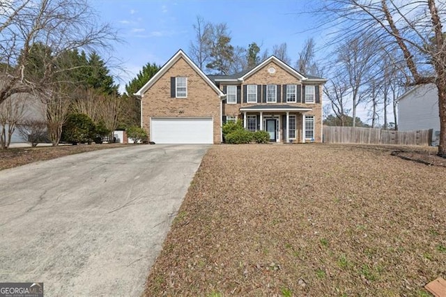 view of front of property with a garage, covered porch, brick siding, fence, and concrete driveway