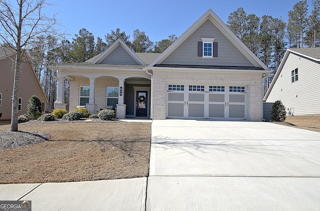 view of front of home with driveway, a garage, and brick siding