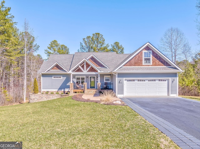 view of front of property with aphalt driveway, a front yard, covered porch, and an attached garage