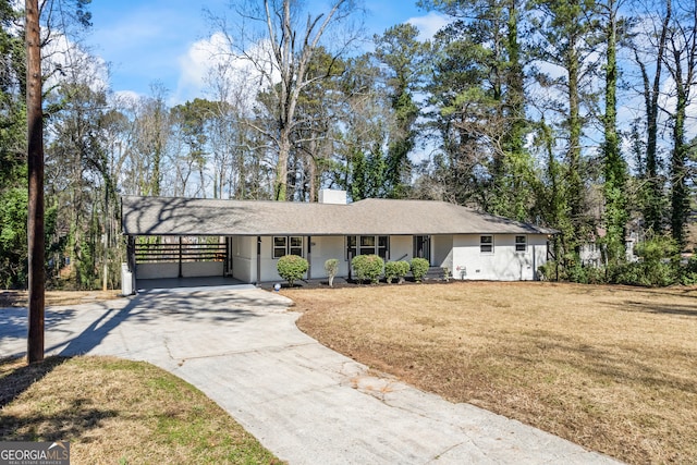 single story home featuring concrete driveway, a front lawn, and an attached carport