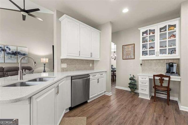 kitchen featuring white cabinets, dishwasher, dark wood-style floors, light countertops, and a sink