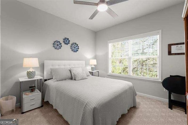 carpeted bedroom featuring ceiling fan and baseboards