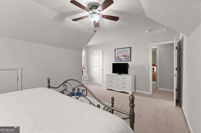 bedroom with a ceiling fan, carpet flooring, vaulted ceiling, and baseboards