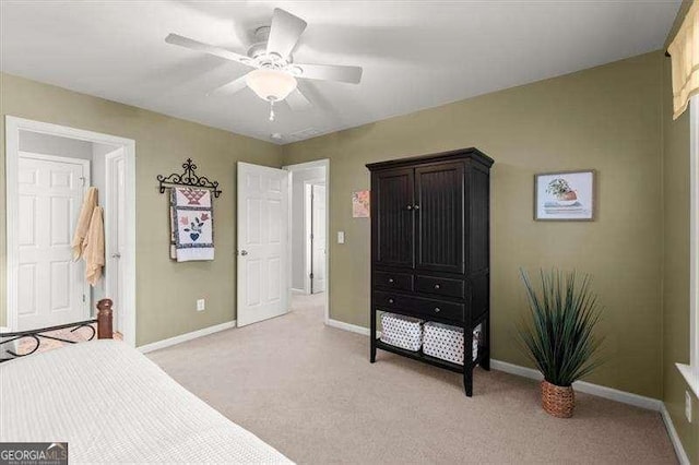 bedroom with light carpet, a ceiling fan, and baseboards