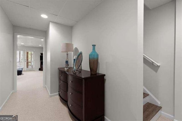 hallway featuring a paneled ceiling, recessed lighting, stairway, light carpet, and baseboards