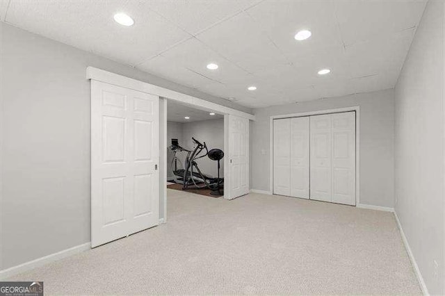 finished basement with carpet, baseboards, and recessed lighting