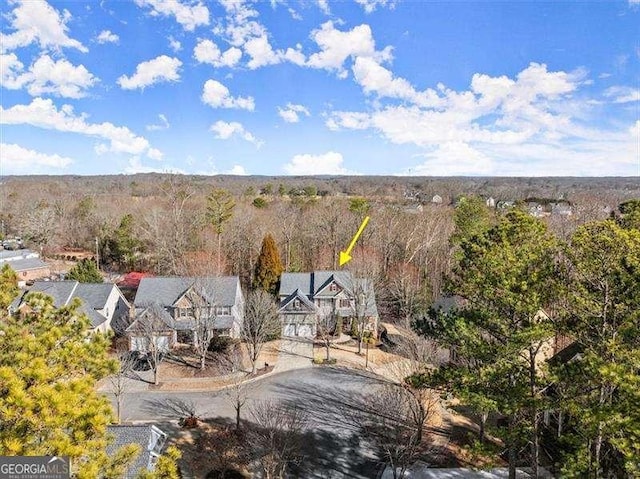 birds eye view of property with a view of trees