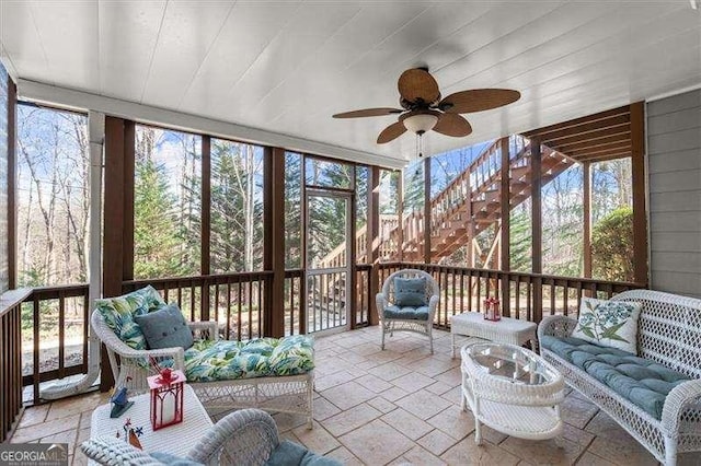 sunroom featuring ceiling fan and a wealth of natural light