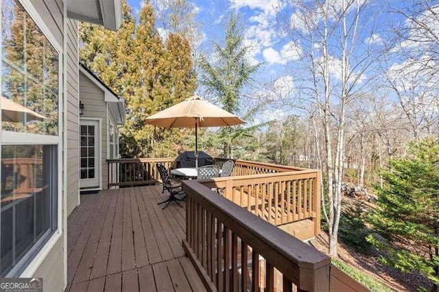 wooden terrace with outdoor dining space