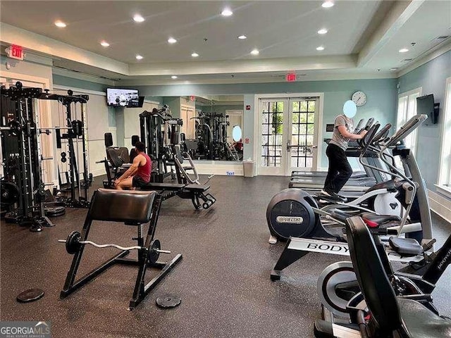 gym with a tray ceiling, french doors, and recessed lighting