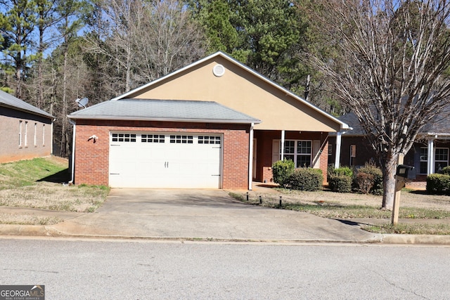 ranch-style house with a garage, brick siding, and driveway