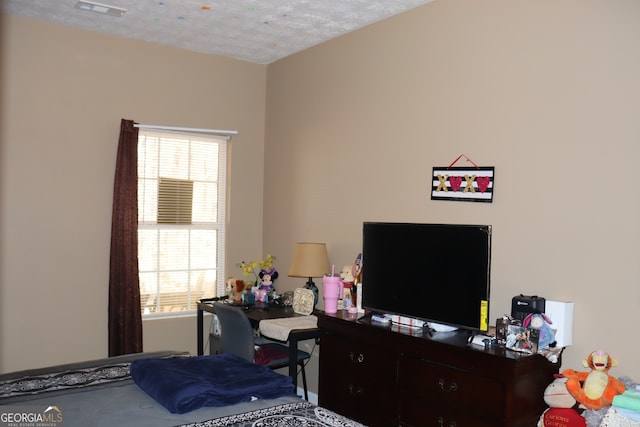 bedroom featuring visible vents and a textured ceiling