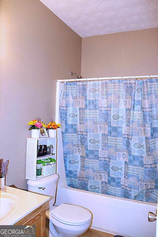 full bathroom featuring vanity, tile patterned flooring, shower / bath combination with curtain, a textured ceiling, and toilet