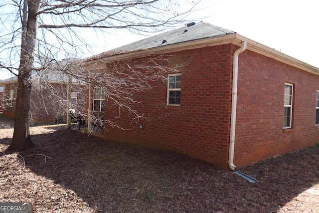 view of side of property featuring brick siding