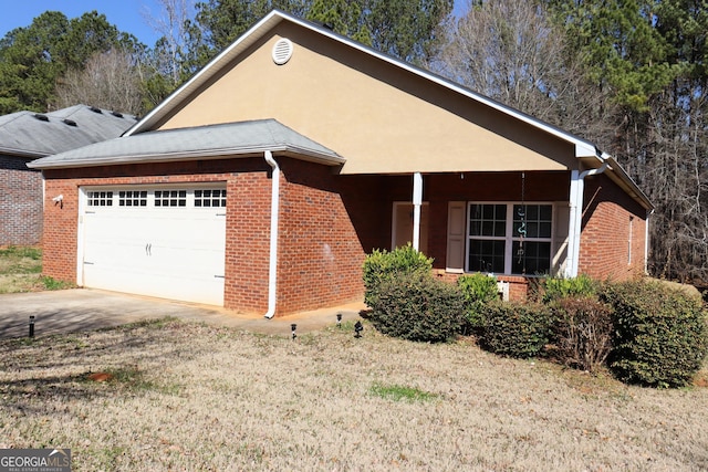 single story home featuring concrete driveway, an attached garage, brick siding, and stucco siding