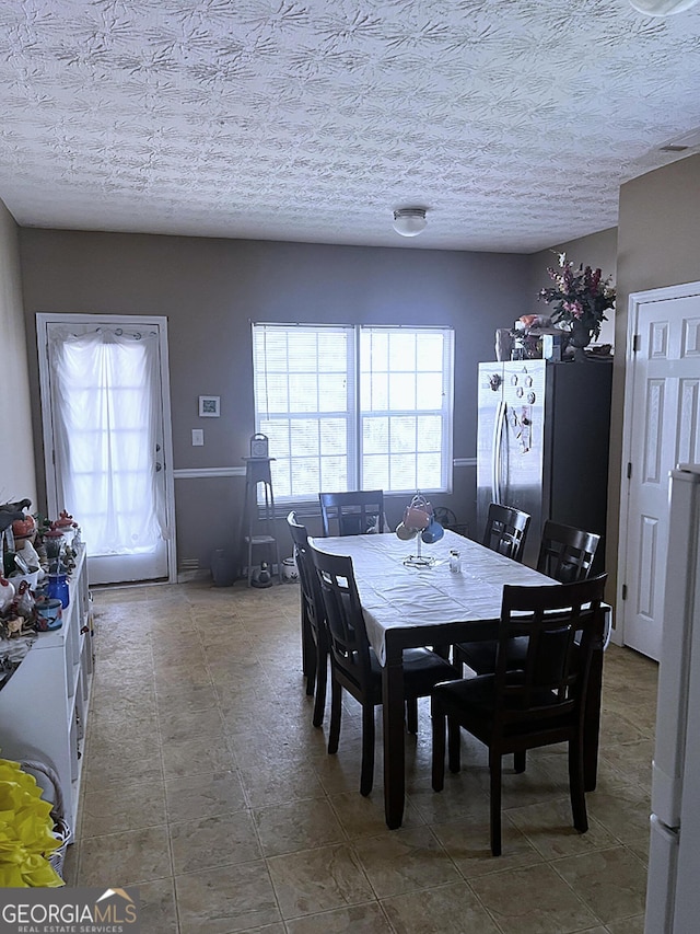 dining room with a textured ceiling