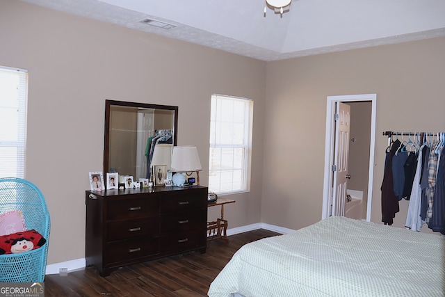 bedroom with visible vents, dark wood-style floors, and baseboards