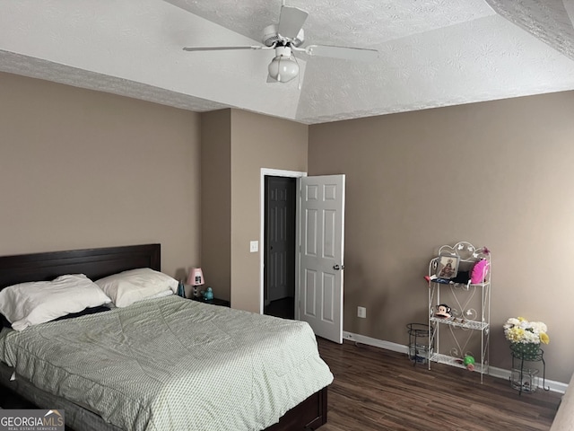 bedroom featuring dark wood-style floors, ceiling fan, a textured ceiling, and baseboards