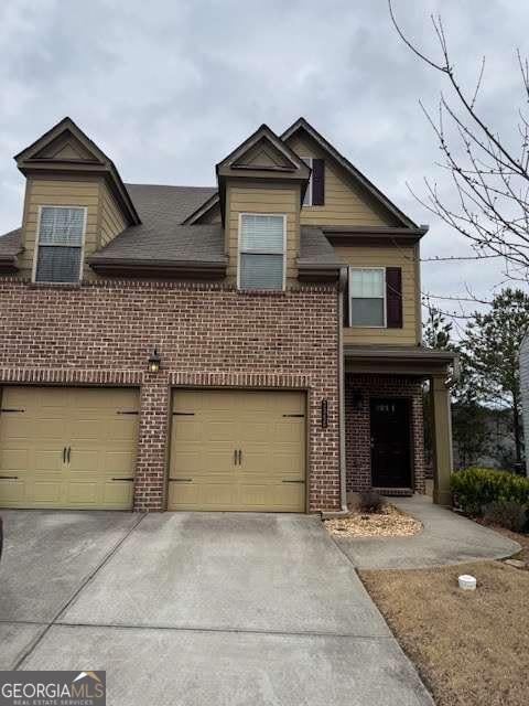 view of front of property with brick siding and driveway