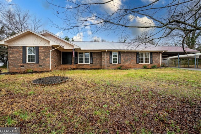 ranch-style home featuring metal roof, an attached carport, crawl space, a front lawn, and brick siding