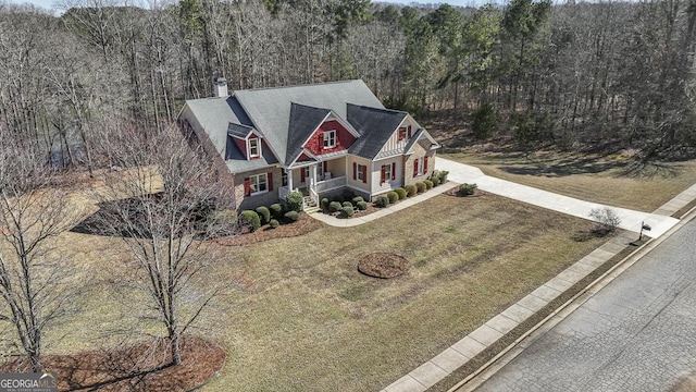 birds eye view of property with a view of trees