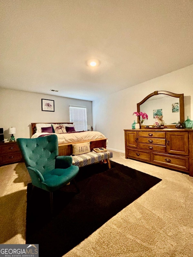 carpeted bedroom featuring visible vents