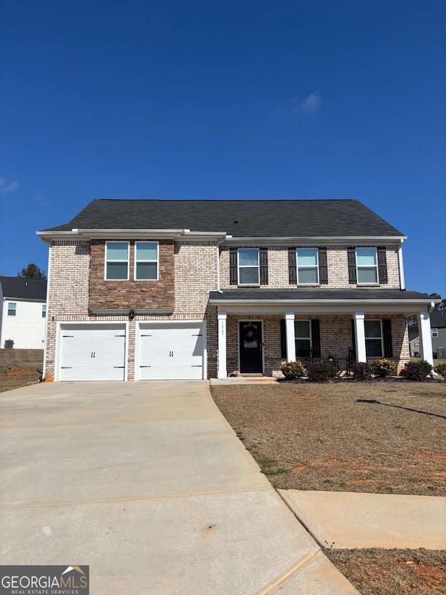 view of front facade featuring a garage, brick siding, driveway, and a porch