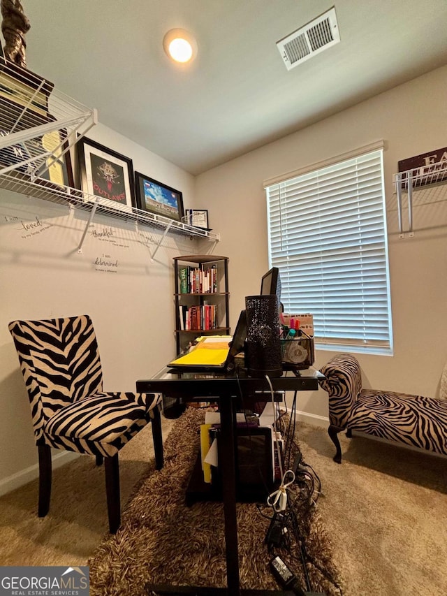 office area featuring baseboards, visible vents, and carpet flooring