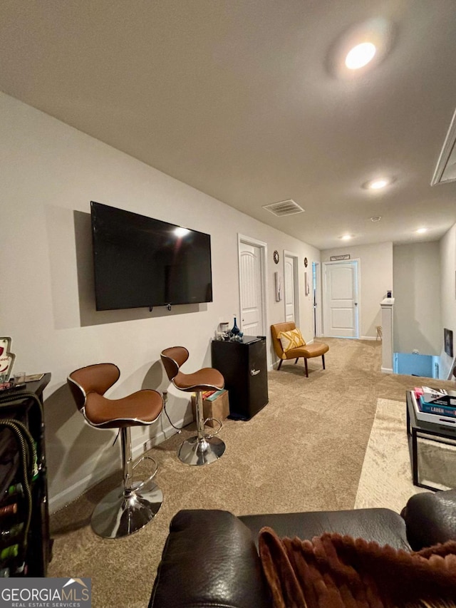 carpeted living room with recessed lighting, visible vents, and baseboards