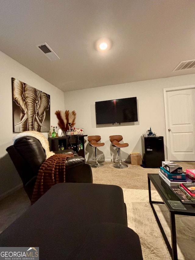 carpeted living area featuring visible vents