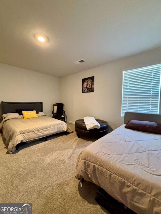 carpeted bedroom with visible vents