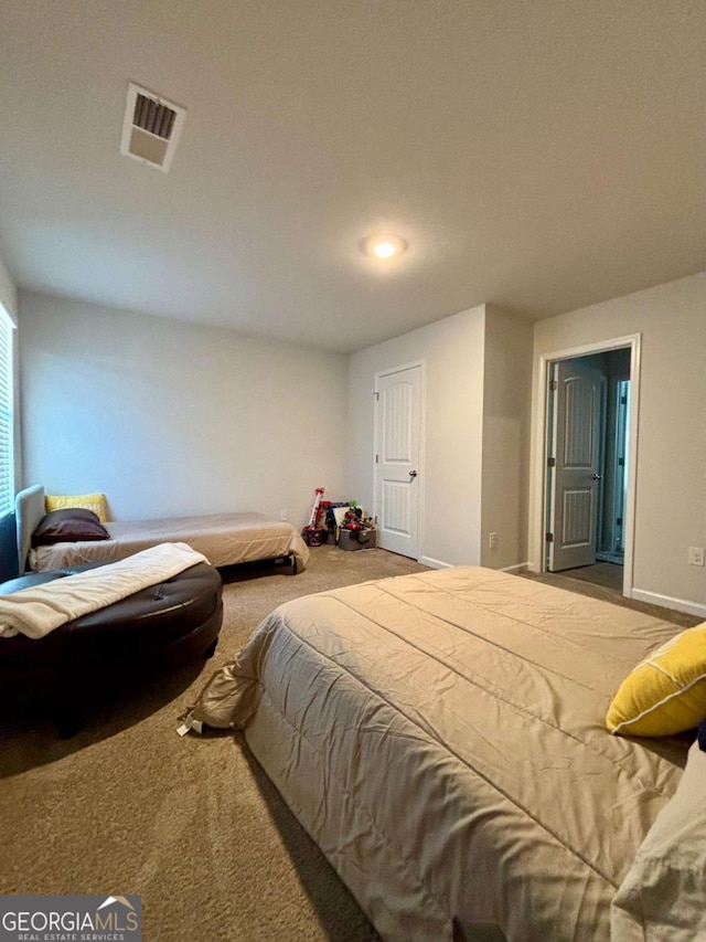 carpeted bedroom with visible vents and baseboards