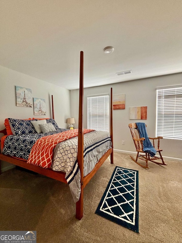 carpeted bedroom with baseboards and visible vents