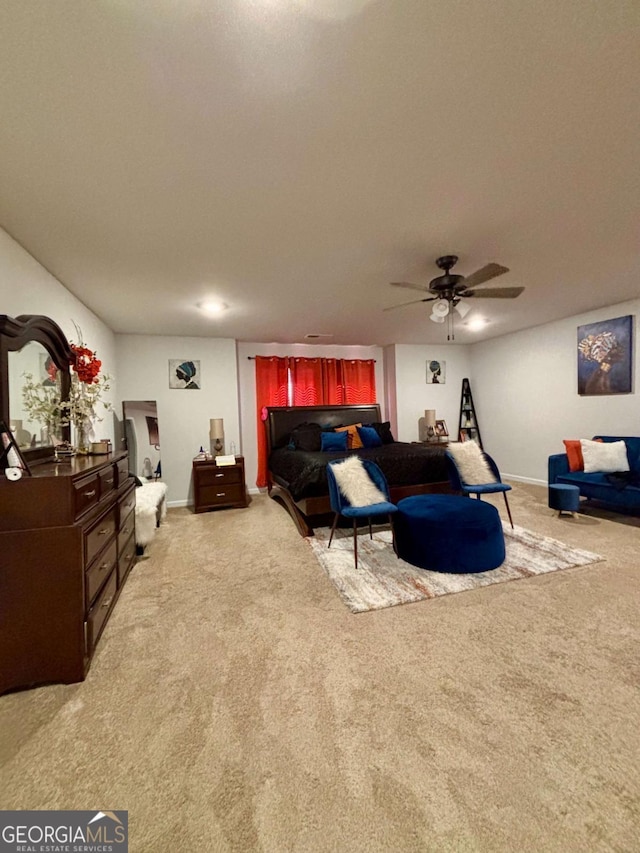 bedroom with baseboards, ceiling fan, and light colored carpet