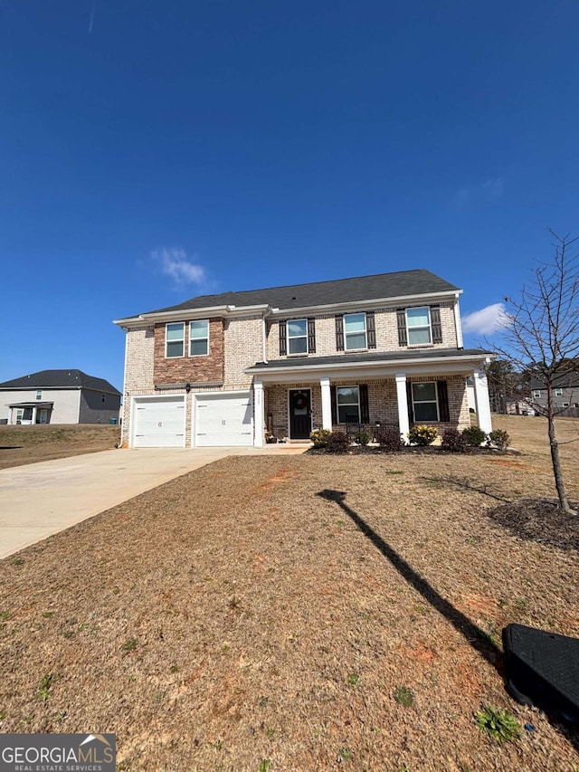 view of front of house with driveway, an attached garage, a porch, and brick siding